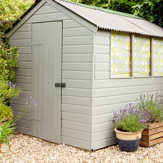 Exterior of grey panelled shed in garden