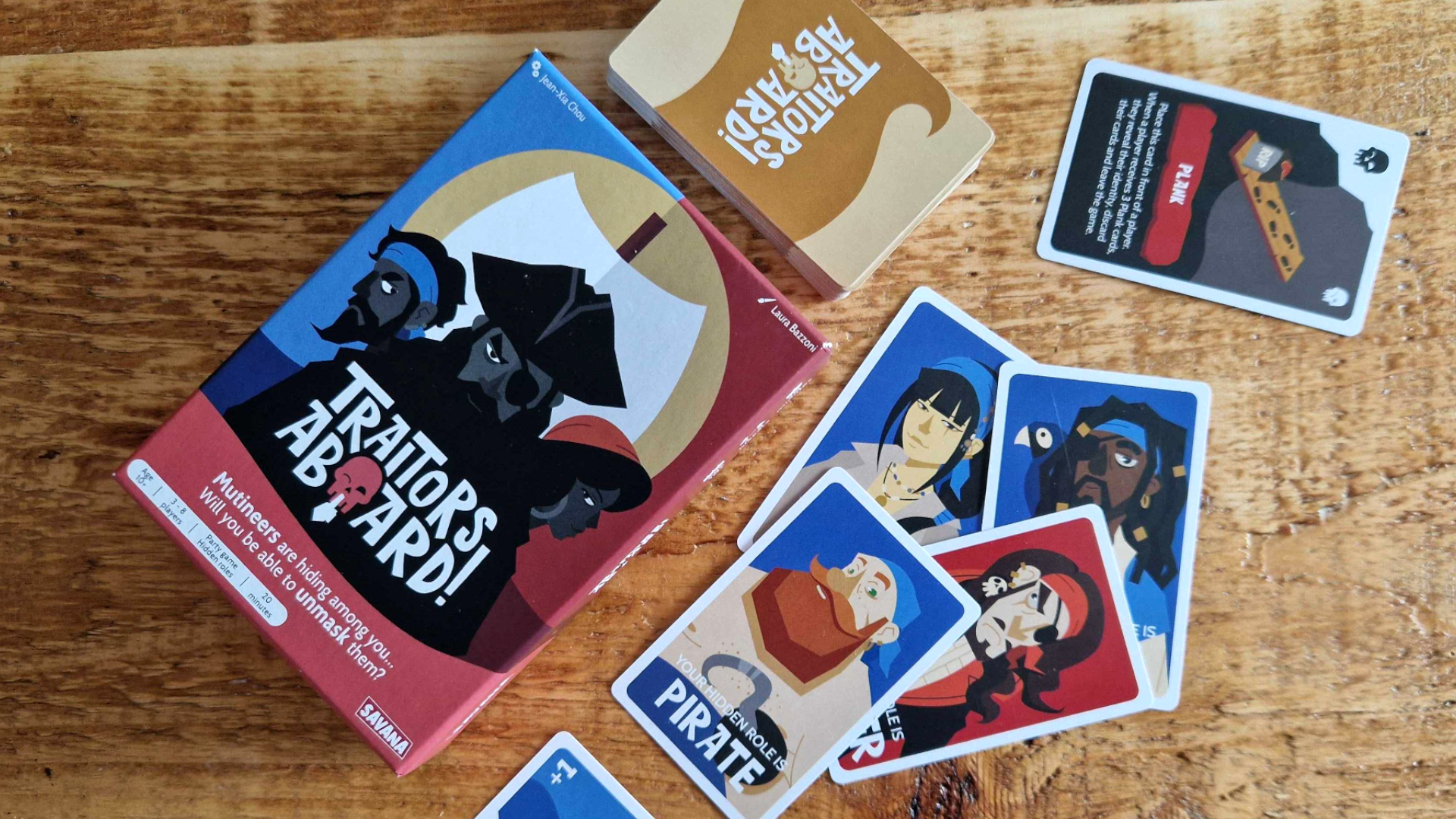Traitors Aboard box and cards laid out on a wooden table