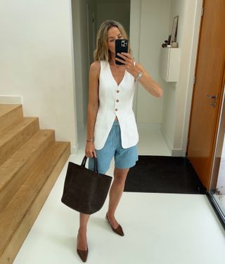 Smart shorts outfits: @anoukyve wears a white waistcoat with denim shorts