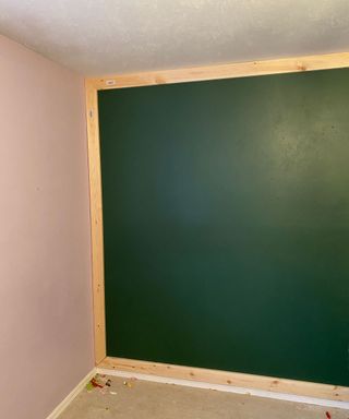 Creating a DIY wooden accent wall painted in green