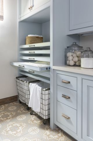 laundry room storage ideas rolling carts in blue laundry room by Marie Flanigan