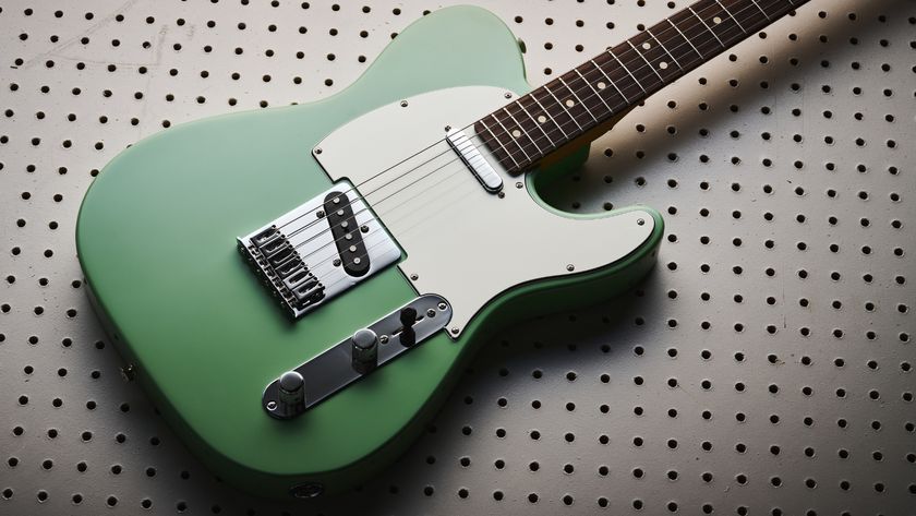 A Fender Player II Telecaster lying on a large, white pegboard