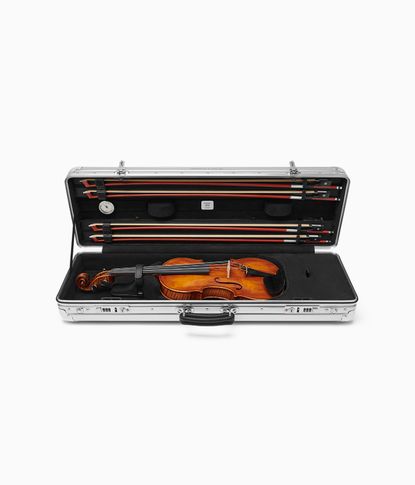 Silver Rimowa violin case, open with violin inside