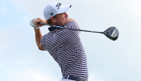 Justin Thomas strikes a tee shot with a driver