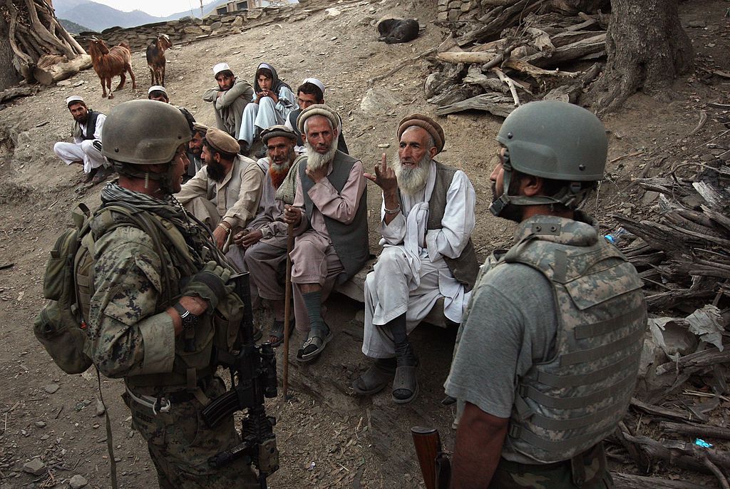 An Afghan interpreter works with a U.S. soldier in 2008.