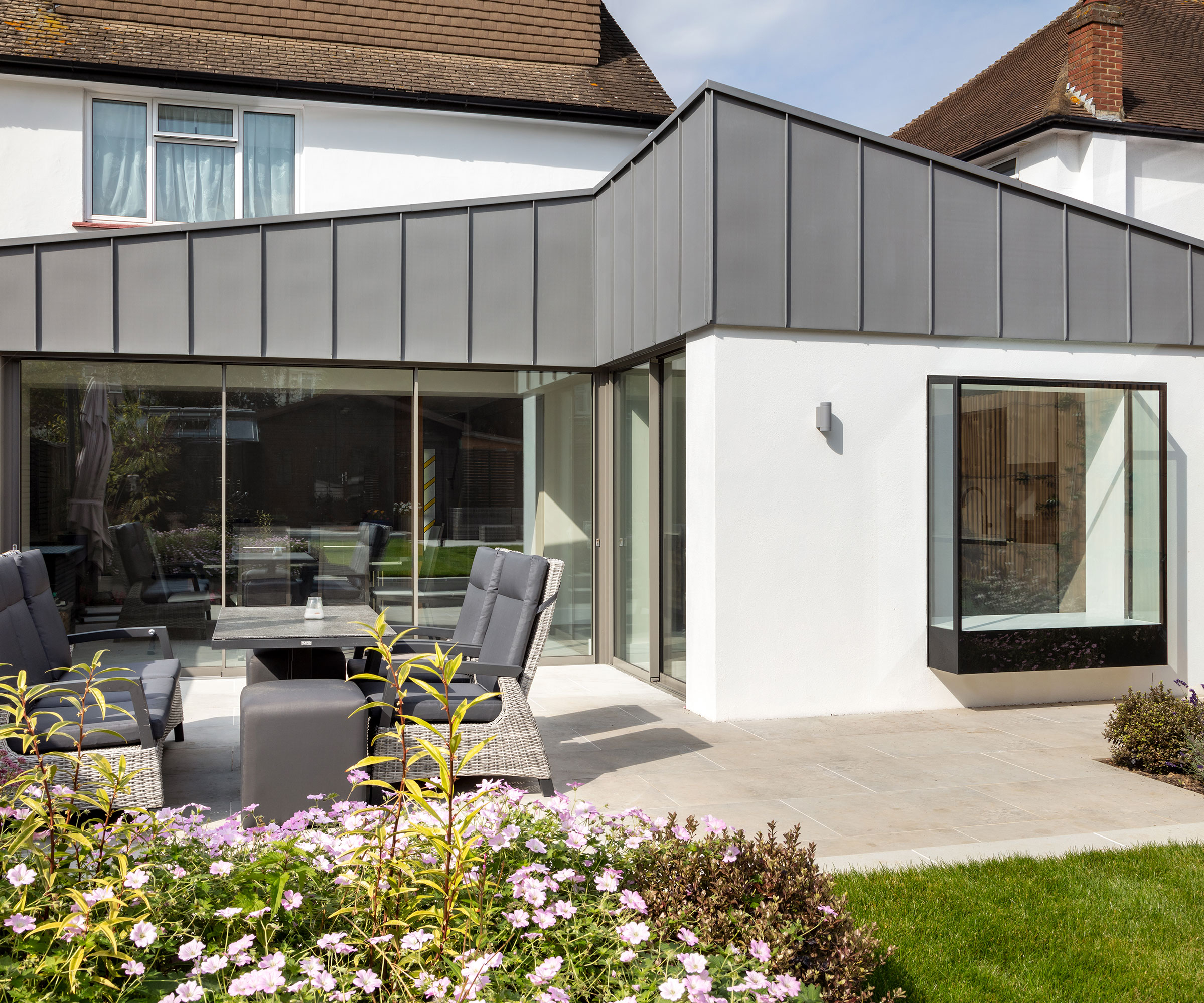 modern L-shaped extension with oriel window