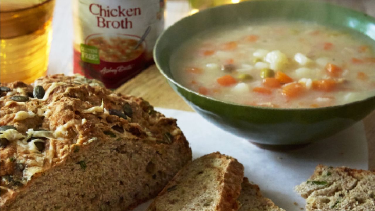 Cheese and chive Irish soda bread with bowl of steaming soup