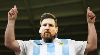 An Argentina fan with a Lionel Messi mask at the 2022 World Cup in Qatar.