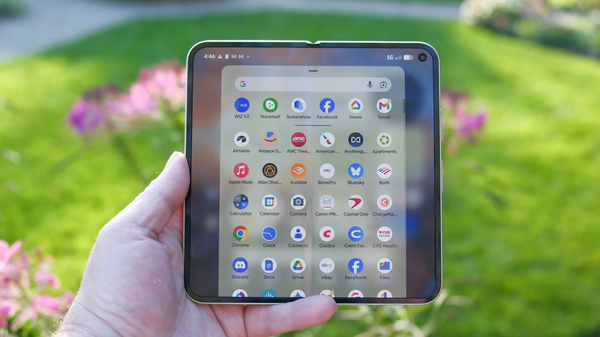 Google Pixel 10 Pro Fold in Jade green outside at a flower garden on a sunny day