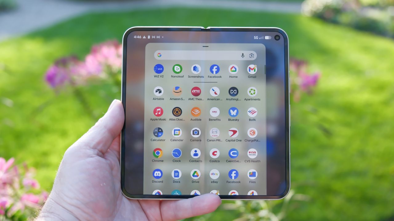 Google Pixel 10 Pro Fold in Jade green outside at a flower garden on a sunny day