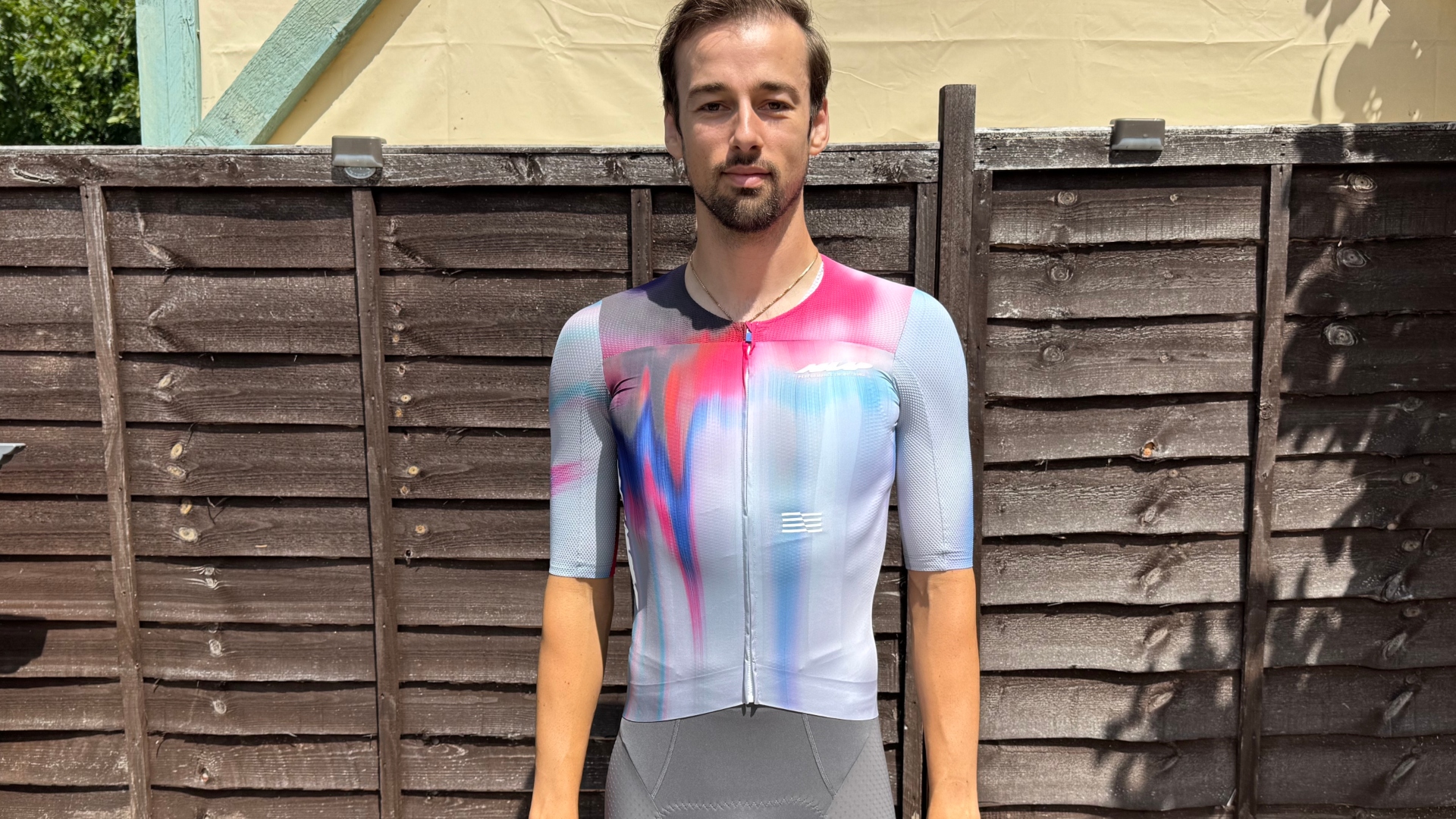 MAAP Pro Race jersey in multiple colours worn by Andy Turner standing in front of a fence