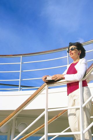 woman looking over cruise ship