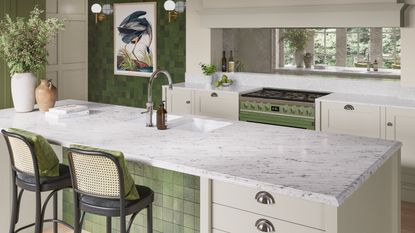 Light grey shaker kitchen with gold hardware and chevron flooring.