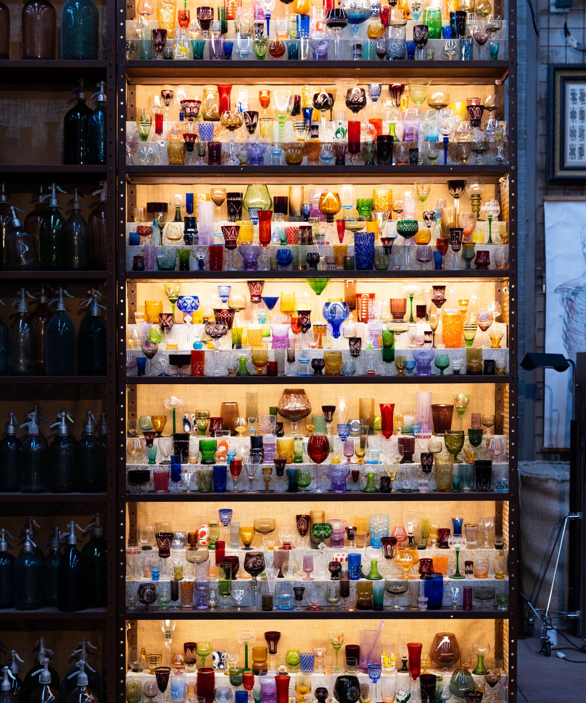 Vintage colored glasses on shelves in cupboard