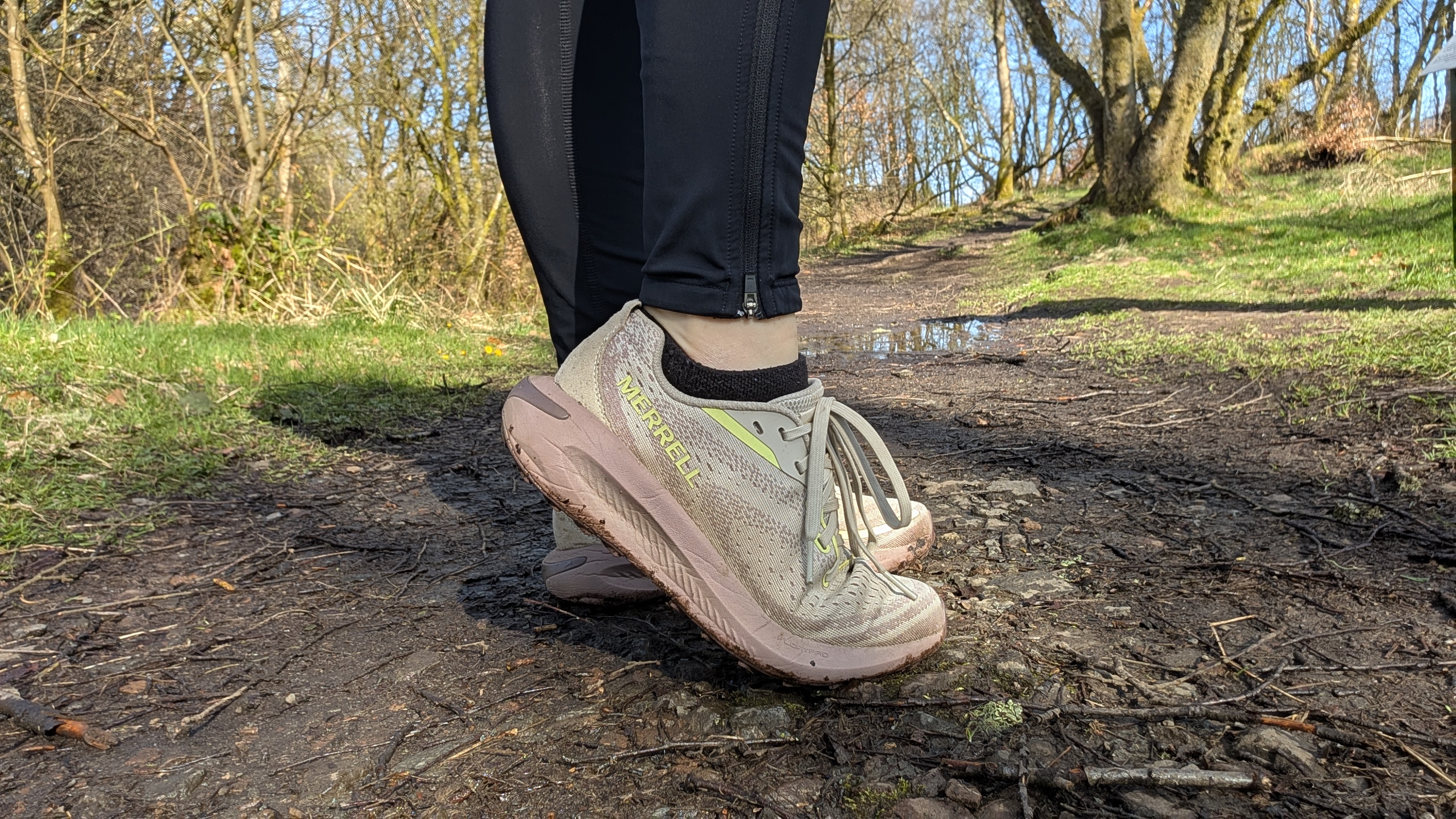 A runner's feet wearing the Merrell Morphlite trail running shoes