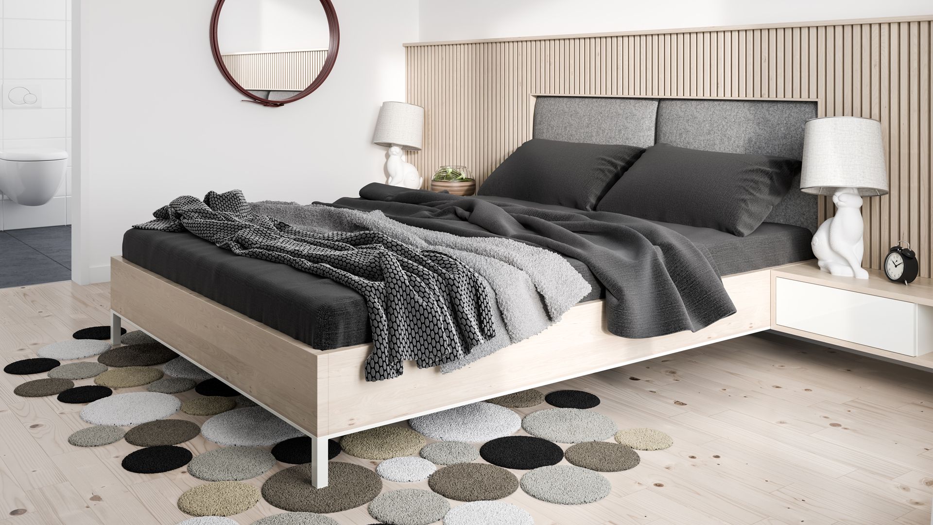 neutral bedroom with layered grey bedding and textured circular grey rug