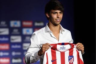 Joao Felix holds an Atletico Madrid shirt after signing for the Rojiblancos from Benfica in July 2019.