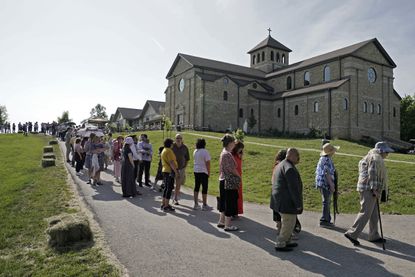 People wait in line to see the exhumed body of Sister Wilhelmina Lancaster.