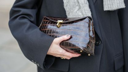 Marissa Cox wears a brown leather bag with crocodile patterns, during a street style fashion photo session, on December 04, 2024 in Paris, France