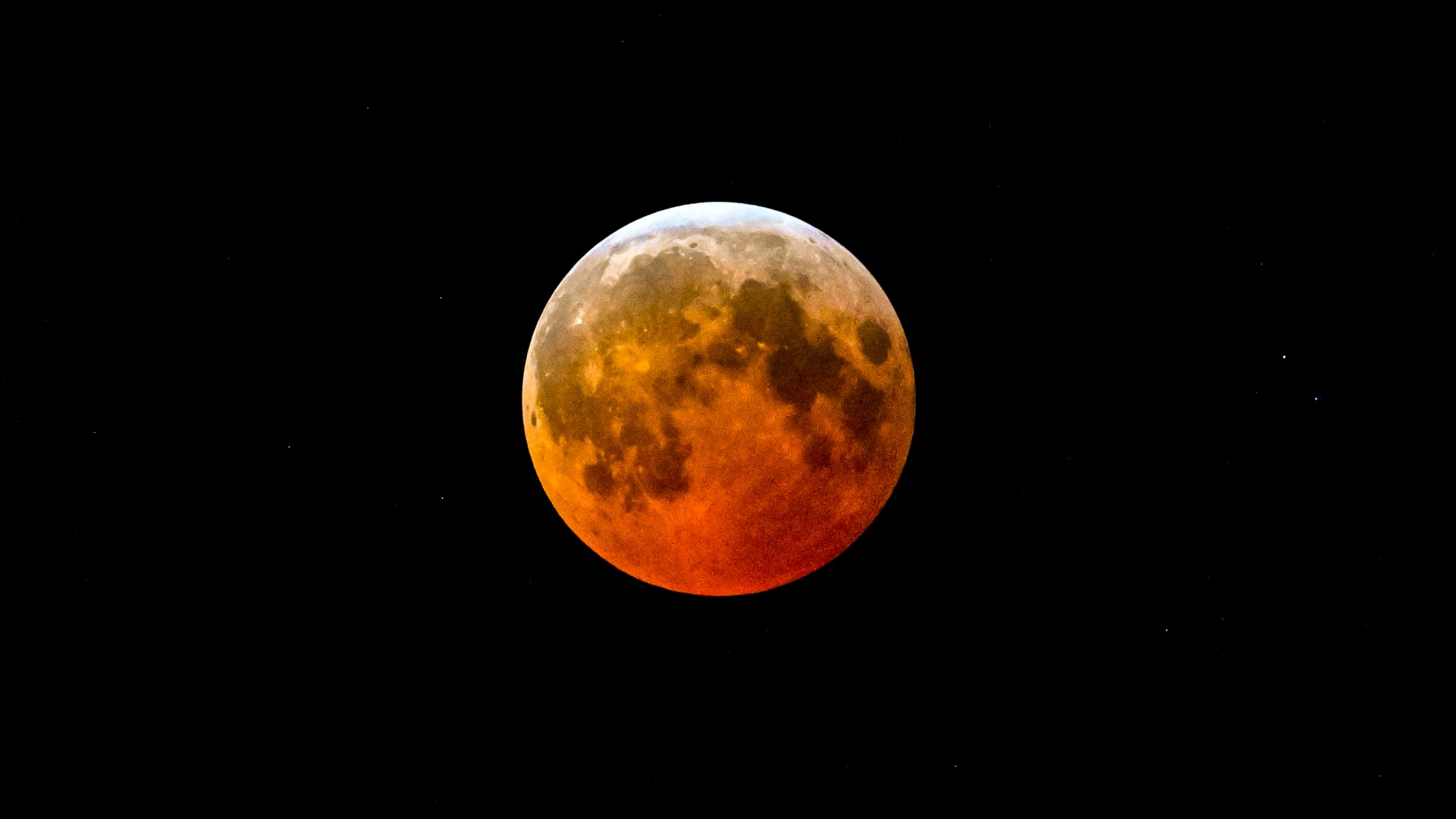 a full red moon on a black background