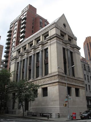 A neoclassical New York building at the corner