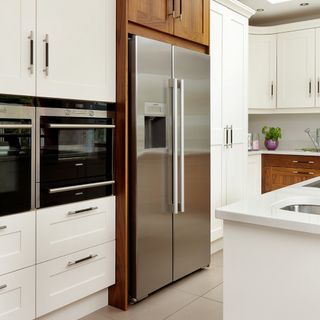 kitchen with white cabinet and stainless steel fridge