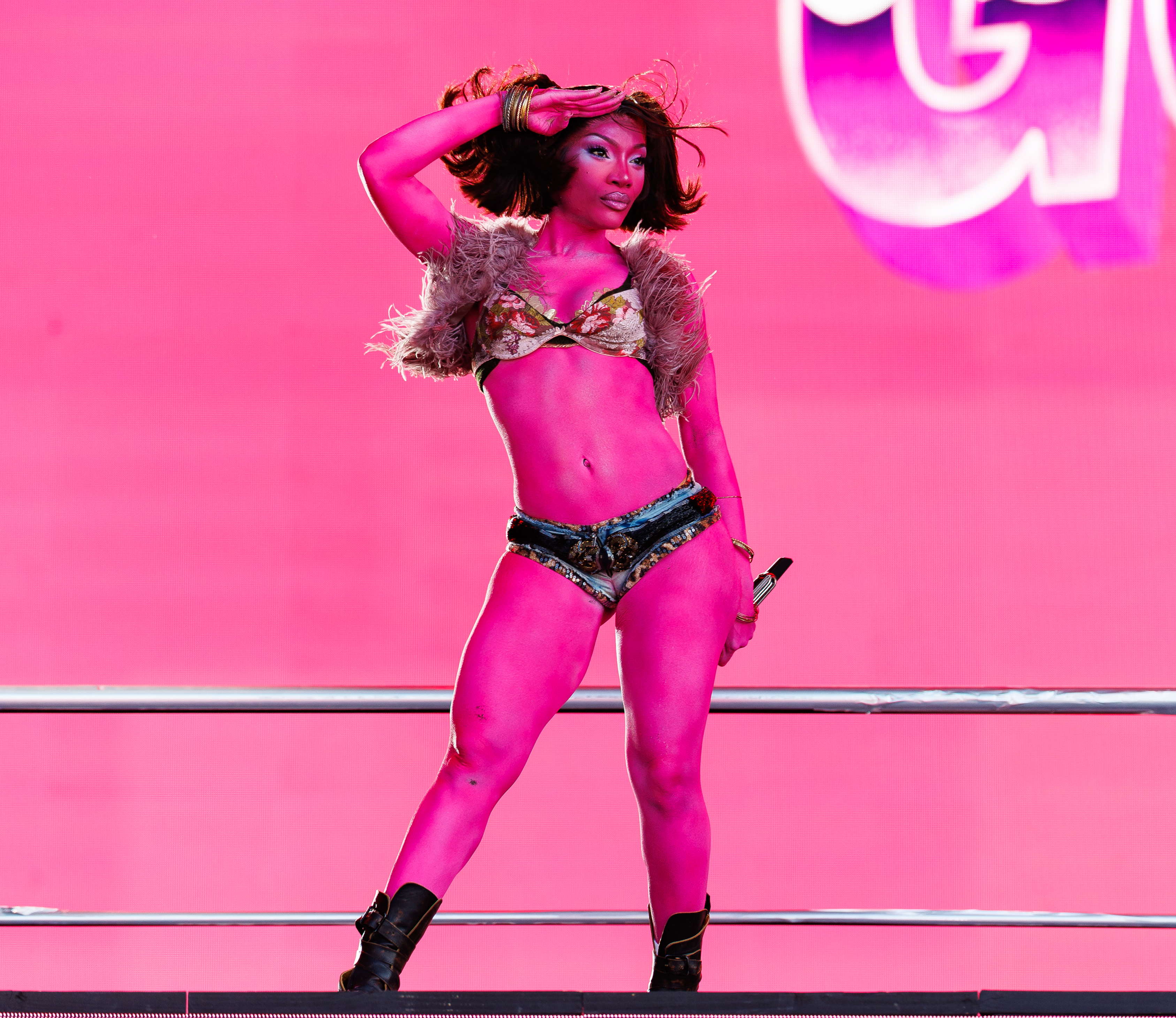 Doechii at Daisy Chain Fields Festival 2026 held at Great Park on August 29, 2026 in Irvine, California in neon pink body paint and biker boots
