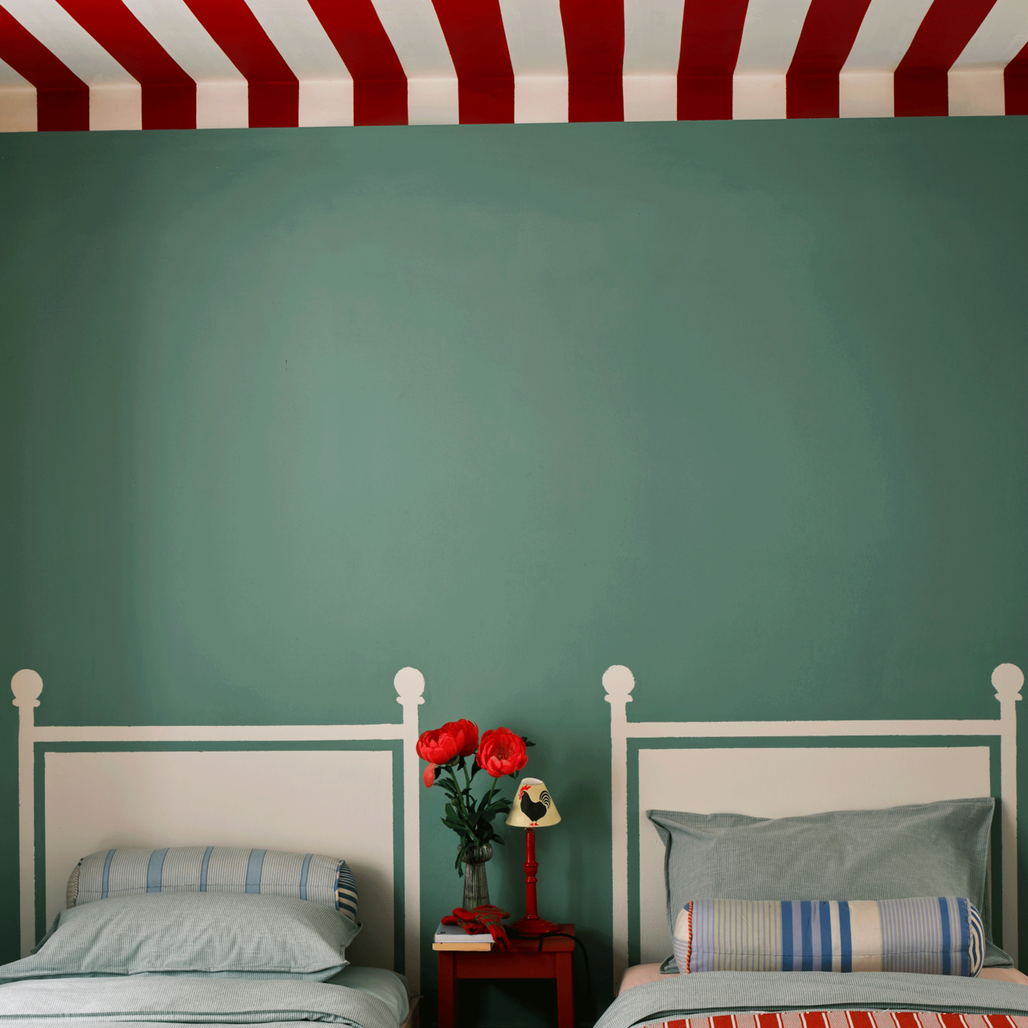 Striped red and white ceiling and white painted headboard