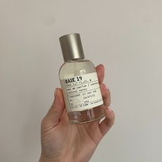 Hand holding bottle of Le Labo Baie 19 Eau de Parfum