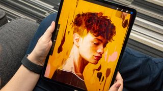 The best iPad for drawing: A person holding an iPad Pro 12.9 in their lap