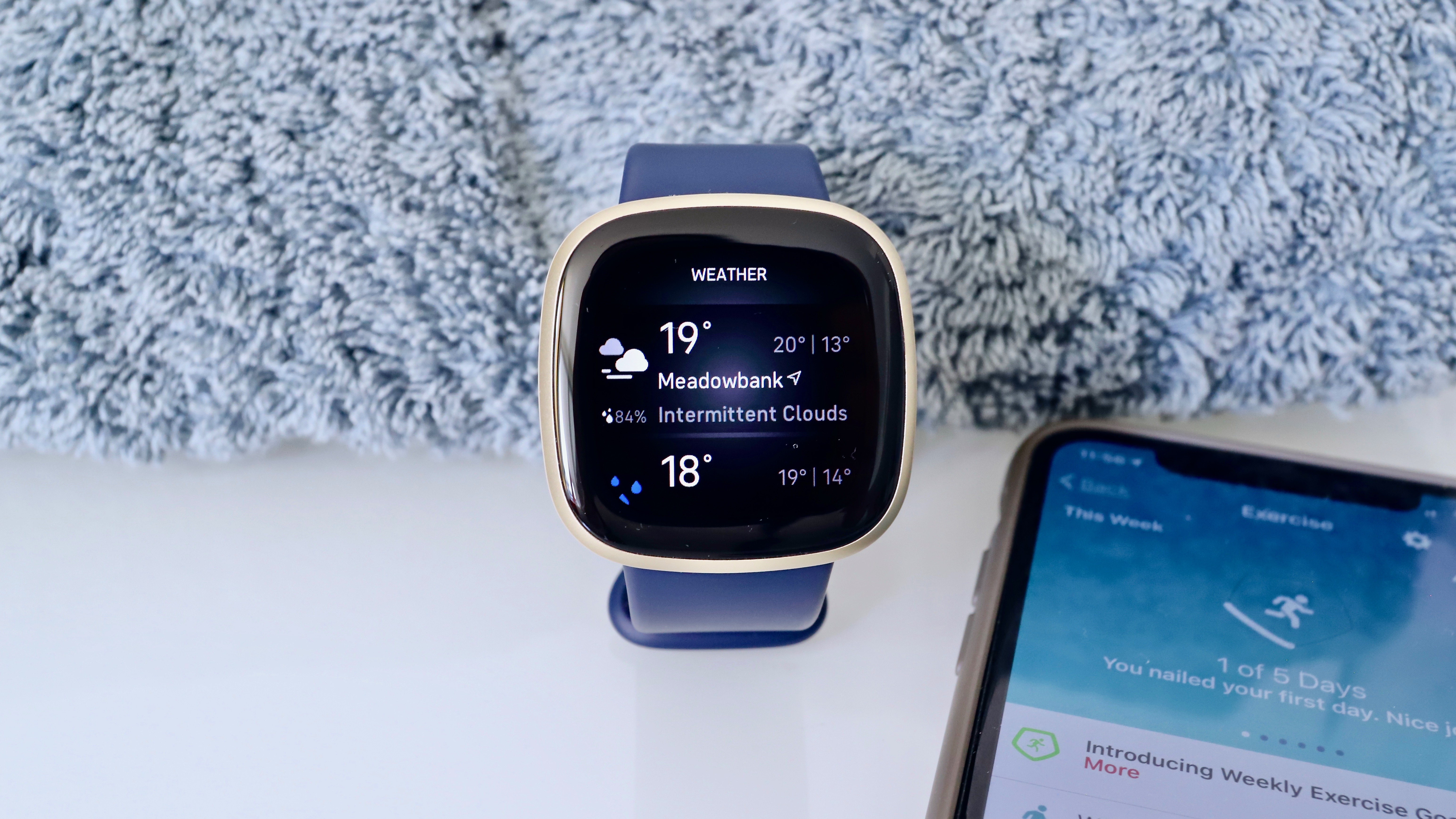 Fitbit Versa 3 with weather app on screen