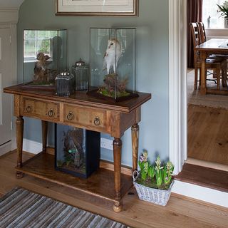 hallway with soft blue walls and antique console table