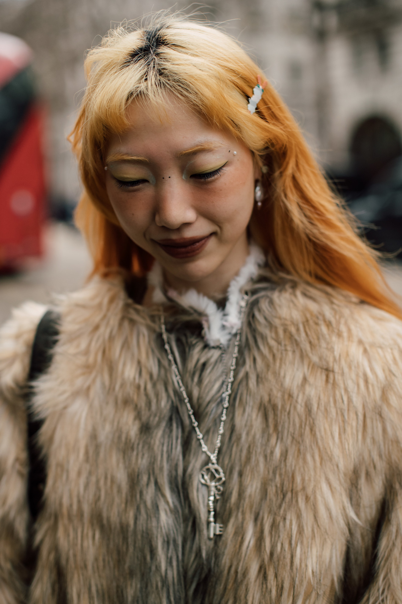 a woman in a fur coat with yellow and orange hair