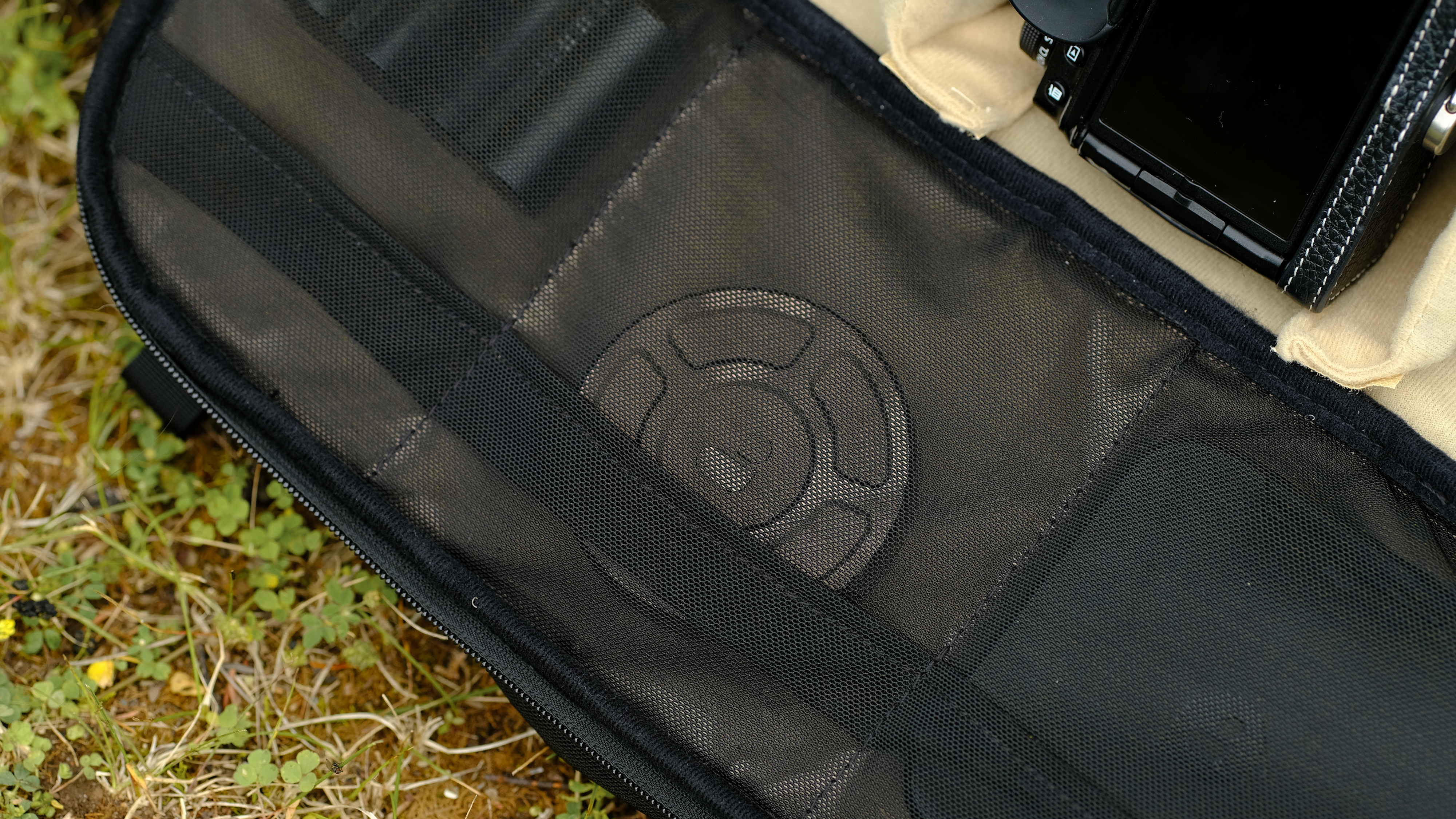 The PolarPro RoadRunner 16L camera backpack outside with wildflowers