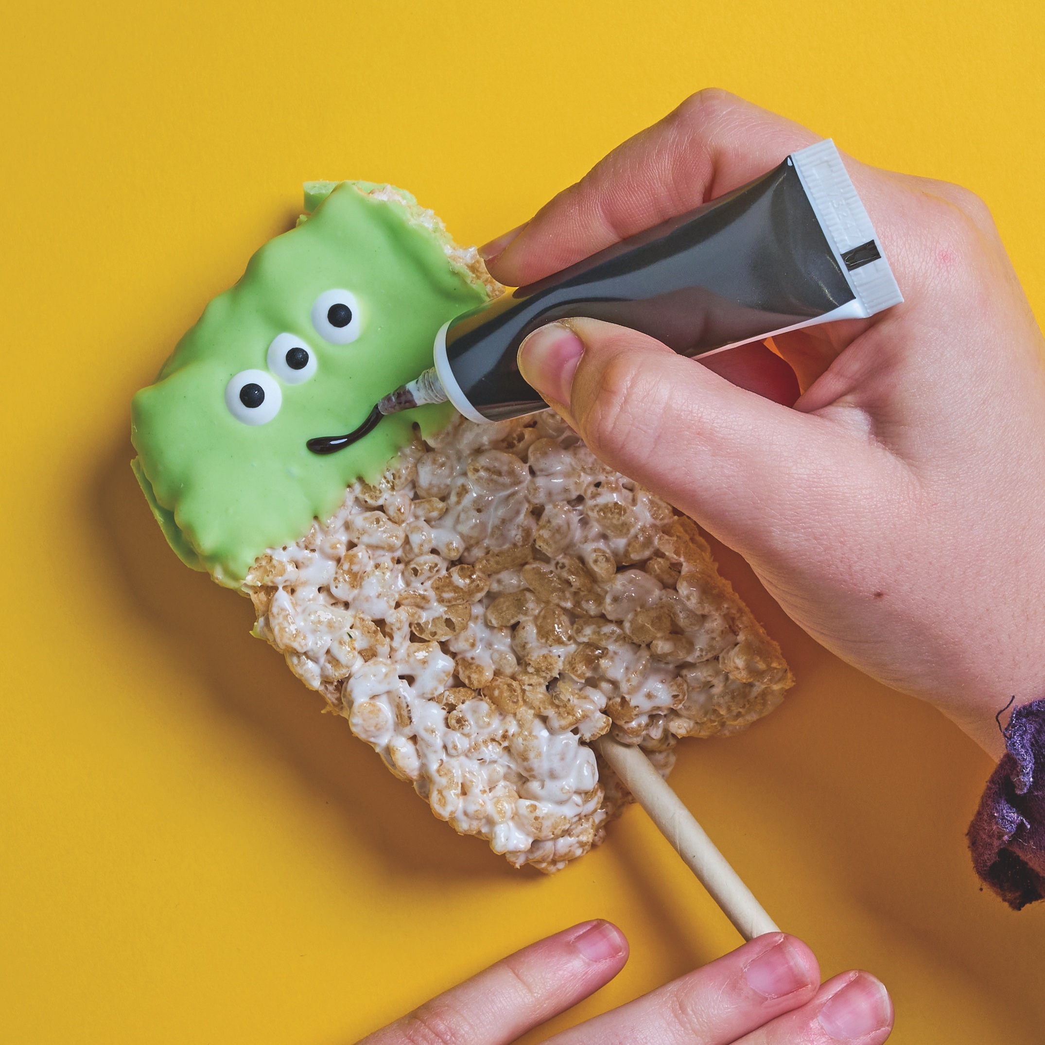 Drawing a smille on a puffed rice alien stick