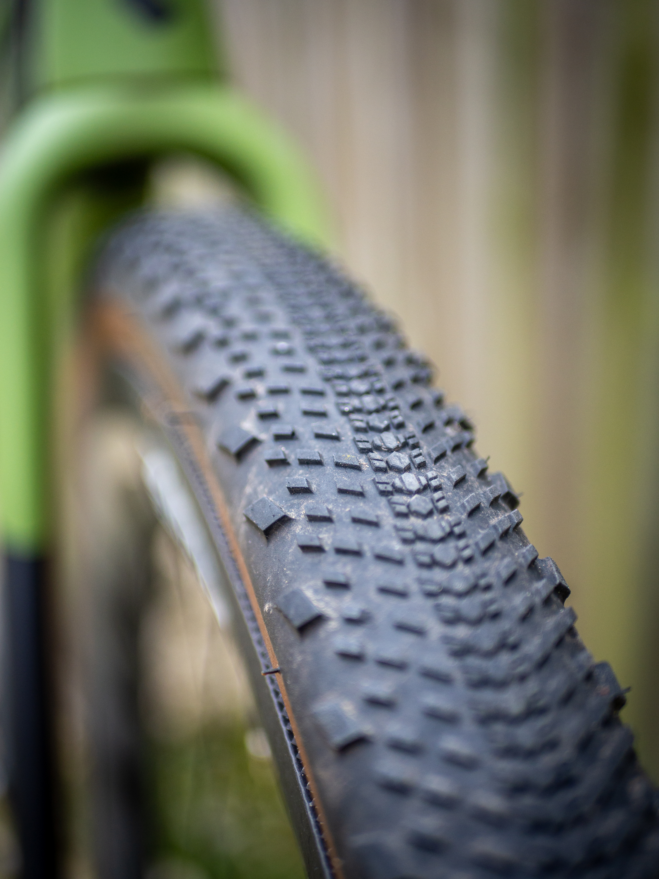 Detail photo of a green Ridley ASTR RS leaning against a wooden fence