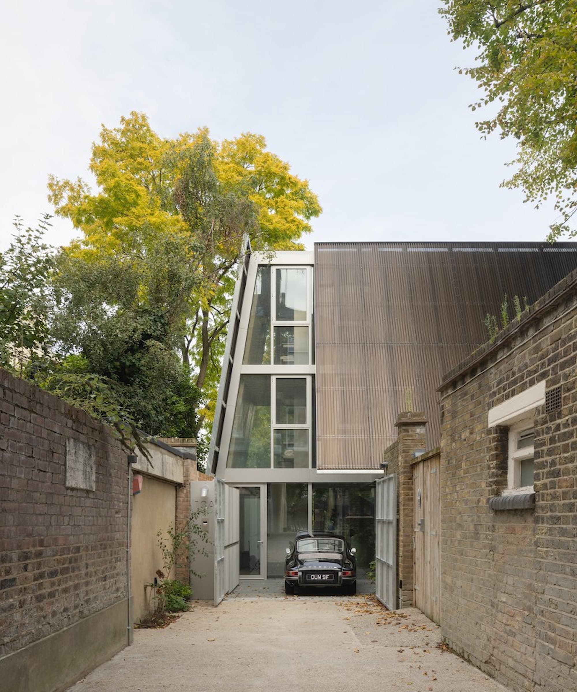 A driveway leading to a front door with a classic car parked in front