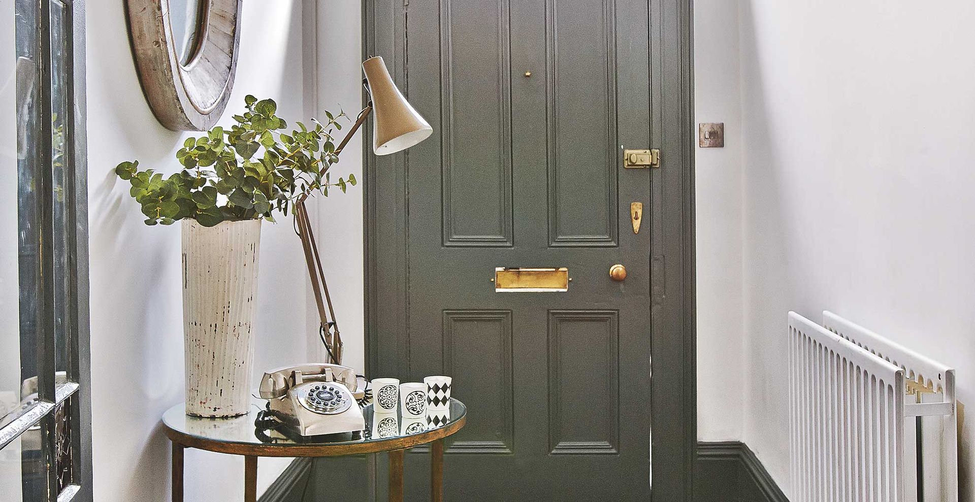 Hallway with a console table with lamp and candles to show scent-scaping in a hallway