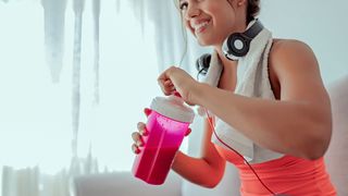 woman mixing up a protein shake