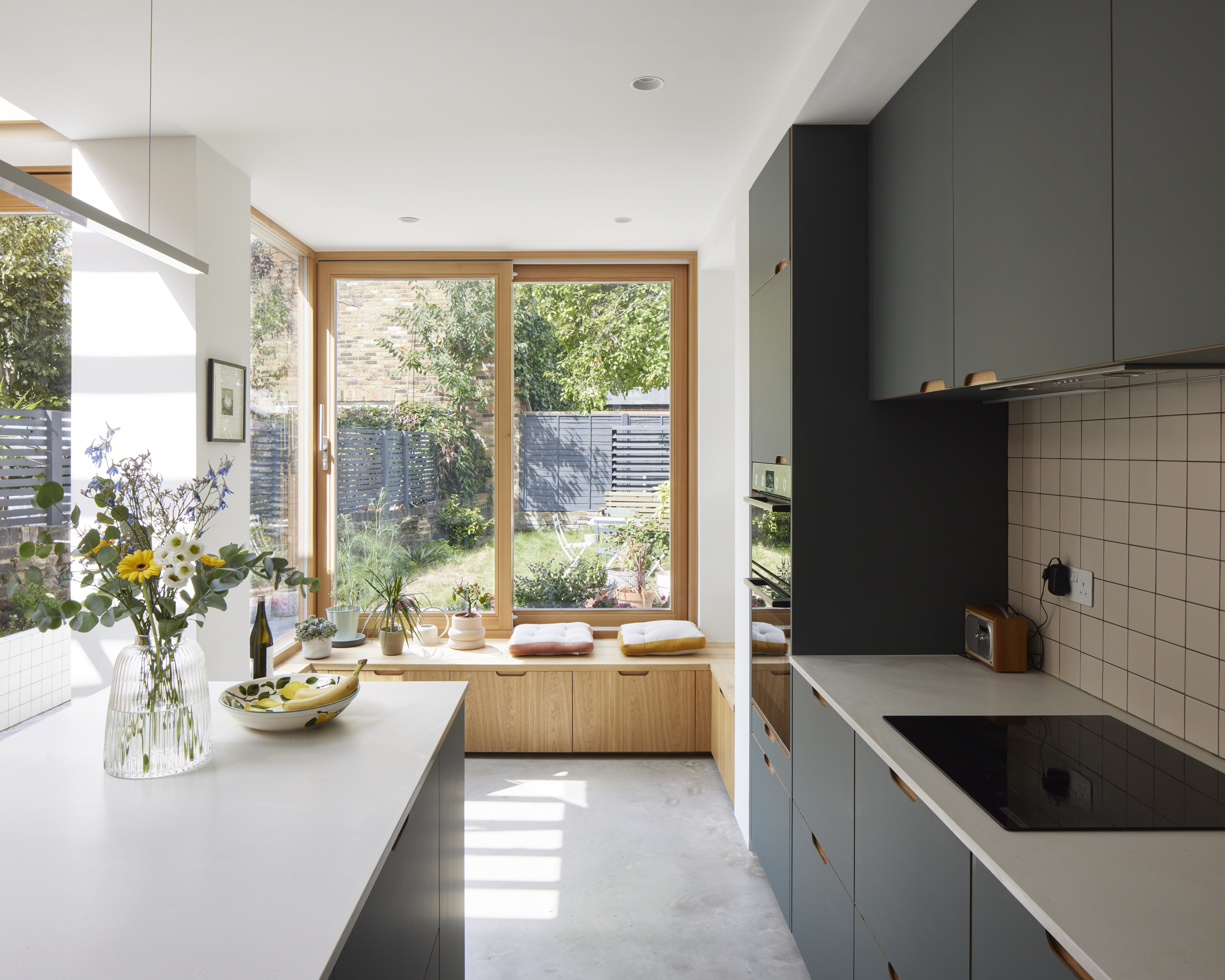 galley kitcehn with floor-to-ceiling windows and contrasting cabinetry