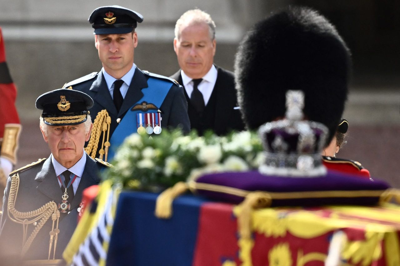 King Charles III (L) and Britain&#039;s Catherine, Princess of Wales walk behind the coffin of Queen Elizabeth II, adorned with a Royal Standard and the Imperial State Crown and pulled by a Gun Carriage of The King&#039;s Troop Royal Horse Artillery, during a procession from Buckingham Palace to the Palace of Westminster, in London on September 14, 2022. - Queen Elizabeth II will lie in state in Westminster Hall inside the Palace of Westminster, from Wednesday until a few hours before her funeral on Monday, with huge queues expected to file past her coffin to pay their respects. (Photo by Marco BERTORELLO / AFP) (Photo by MARCO BERTORELLO/AFP via Getty Images)