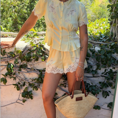 Fashion person shhtephs wears a two piece Doen set. 