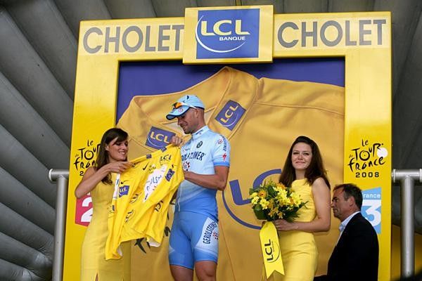 Stefan Schumacher (Gerolsteiner) accepts the yellow jersey as Bernhard Hinault looks on.