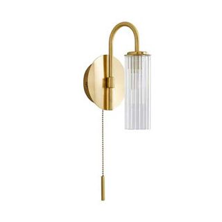 brass wall light with fluted glass shade