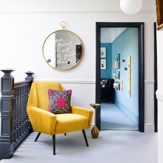 hallway landing beside stairs yellow velvet armchair etched mirror