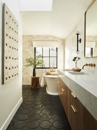 black and white bathroom with fluted wood cabinets and off-white tile.