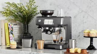 The Sage Barista Touch coffee machine on a marble kitchen countertop