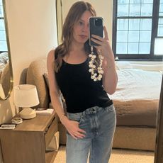 Nikki wears a flore flore black tank and jeans.