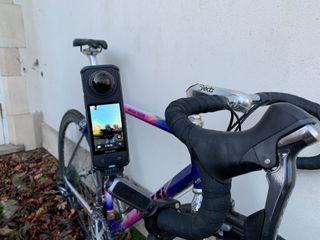 Insta360 X4 is attached to a bikes handlebars