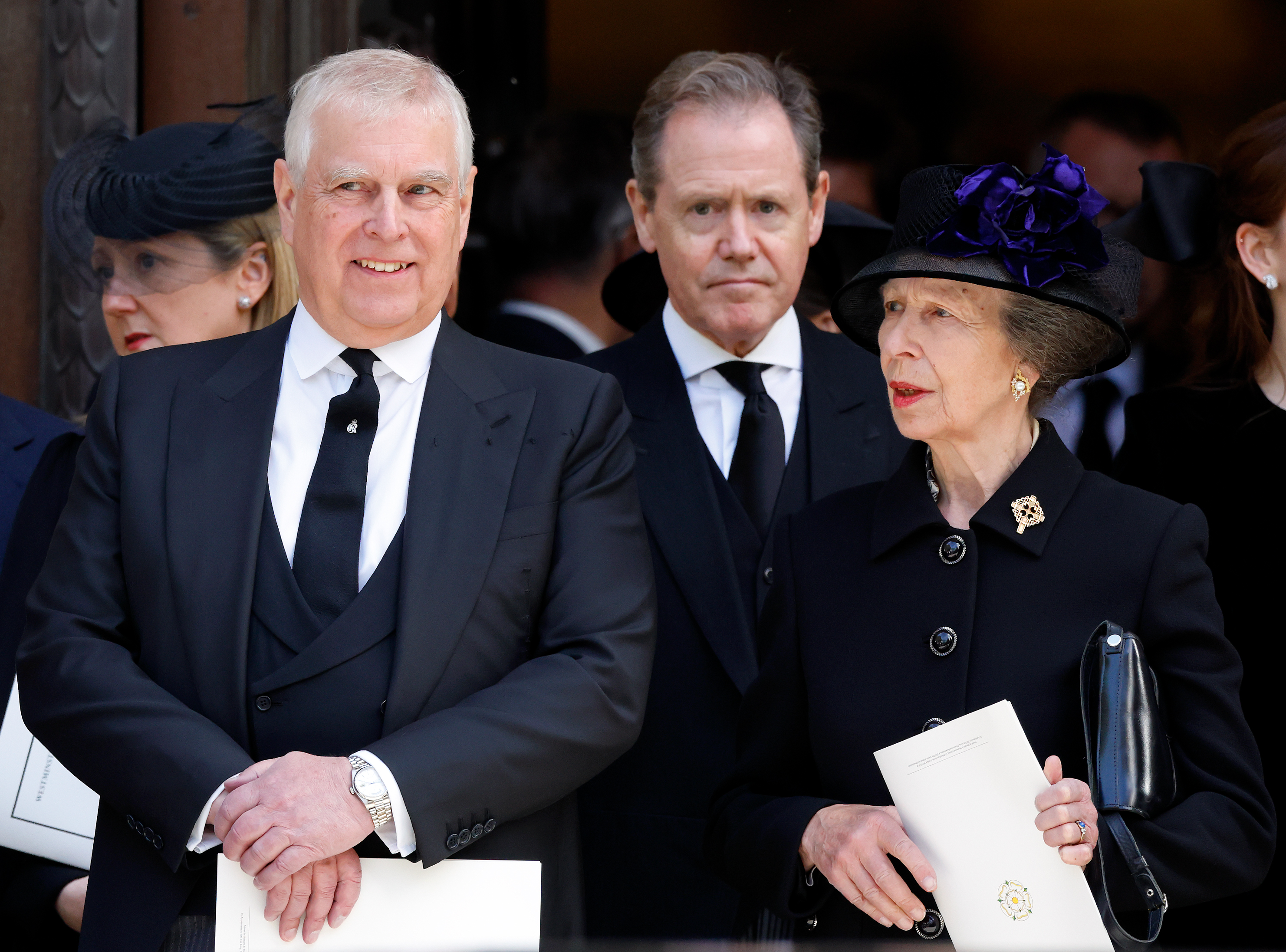 Prince Andrew and Princess Anne talking at the Duchess of Kent's funeral